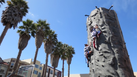 Teens take-on the rock-climbing challenge at the SOMA recreation center. 